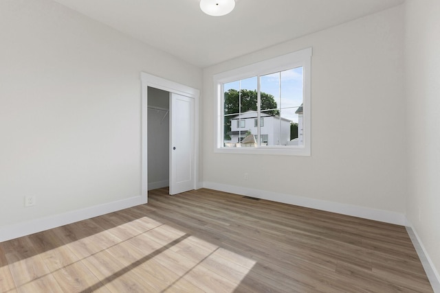 1817 N Arties Rd, Spokane Valley, WA 99016 - unfurnished bedroom featuring baseboards, light wood finished floors, and a closet