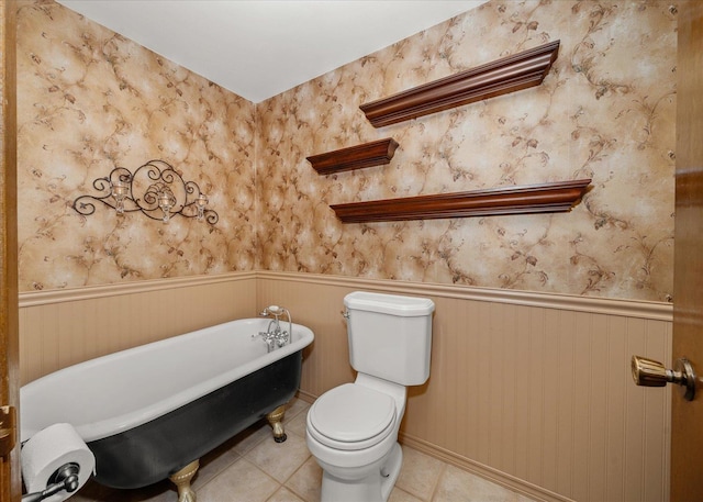16905 N Mockingbird Ct, Nine Mile Falls, WA 99026 - full bath featuring a wainscoted wall, a freestanding bath, toilet, tile patterned floors, and wallpapered walls