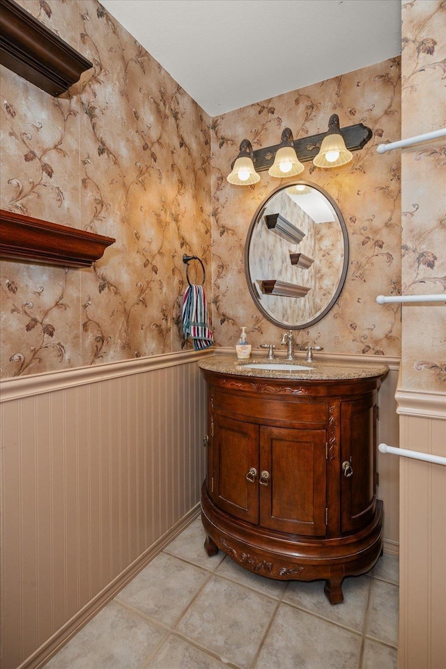 16905 N Mockingbird Ct, Nine Mile Falls, WA 99026 - bathroom featuring a wainscoted wall, vanity, tile patterned flooring, and wallpapered walls