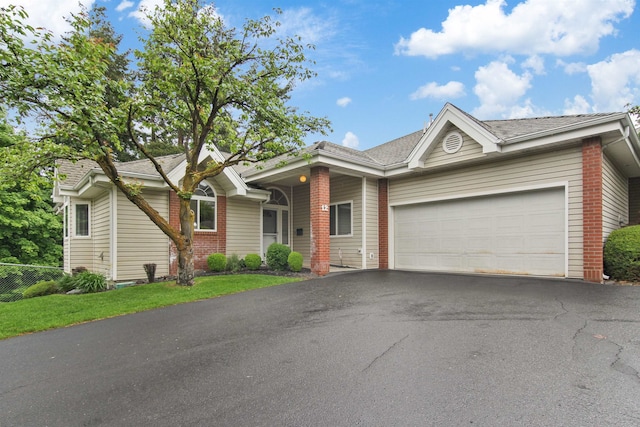 221 E Rockwood Blvd Unit 12, Spokane, WA 99202 - ranch-style home featuring asphalt driveway, brick siding, and an attached garage