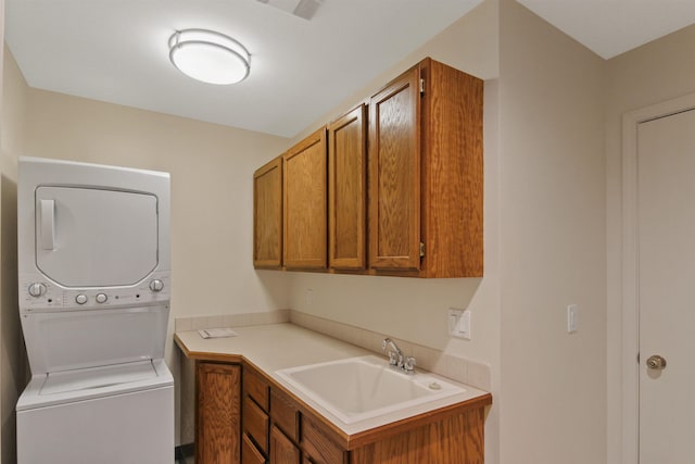 221 E Rockwood Blvd Unit 12, Spokane, WA 99202 - washroom featuring stacked washer / dryer and cabinet space