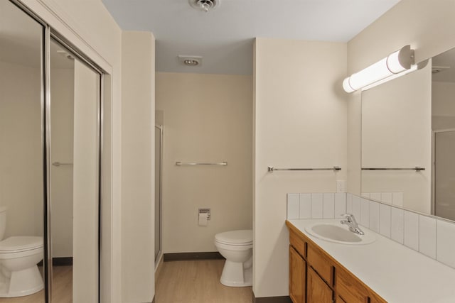 221 E Rockwood Blvd Unit 12, Spokane, WA 99202 - bathroom with toilet, wood finished floors, a stall shower, and vanity