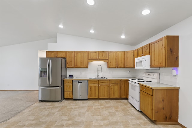 6021 N Addison St, Spokane, WA 99208 - kitchen with stainless steel appliances, a sink, vaulted ceiling, light countertops, and stone finish flooring