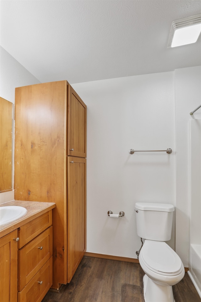 6021 N Addison St, Spokane, WA 99208 - bathroom featuring vanity, wood finished floors, toilet, and tub / shower combination