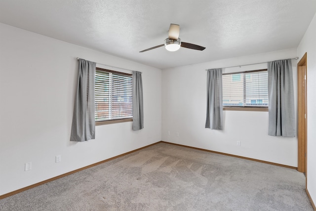 6021 N Addison St, Spokane, WA 99208 - carpeted spare room with plenty of natural light, ceiling fan, a textured ceiling, and baseboards