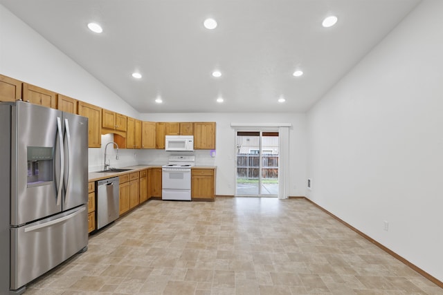 6021 N Addison St, Spokane, WA 99208 - kitchen with appliances with stainless steel finishes, a sink, light countertops, vaulted ceiling, and recessed lighting