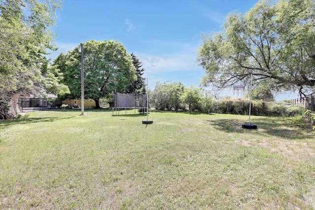 9715 E Nora Ave, Spokane Valley, WA 99206 - view of grassy yard featuring a trampoline