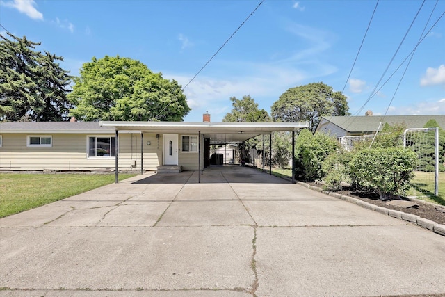 9715 E Nora Ave, Spokane Valley, WA 99206 - view of front of home with concrete driveway, a front yard, a carport, and a chimney