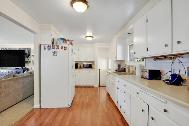 9715 E Nora Ave, Spokane Valley, WA 99206 - kitchen featuring white fridge with ice dispenser, stainless steel microwave, a sink, light wood-type flooring, and white cabinetry