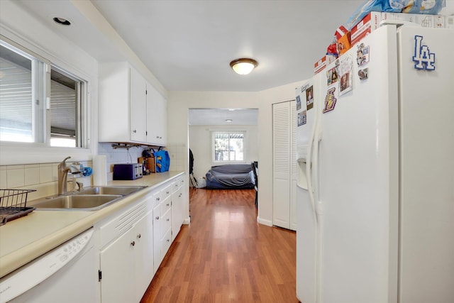 9715 E Nora Ave, Spokane Valley, WA 99206 - kitchen with white appliances, a sink, light wood-style floors, decorative backsplash, and white cabinets