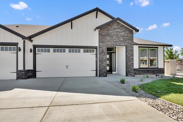 1109 N Country Club Dr Unit 20, Deer Park, WA 99006 - view of front facade with stone siding, an attached garage, board and batten siding, concrete driveway, and a shingled roof