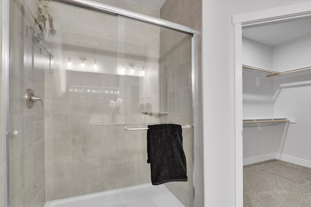 1109 N Country Club Dr Unit 20, Deer Park, WA 99006 - full bathroom featuring a stall shower, a walk in closet, and baseboards