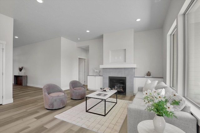 1109 N Country Club Dr Unit 20, Deer Park, WA 99006 - living area with a tiled fireplace, light wood-type flooring, recessed lighting, and baseboards