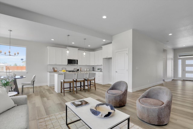 1109 N Country Club Dr Unit 20, Deer Park, WA 99006 - living room with light wood-style flooring, a chandelier, recessed lighting, and baseboards