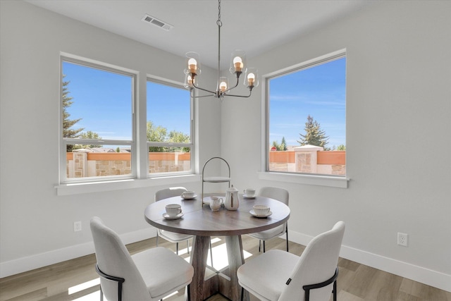 1109 N Country Club Dr Unit 20, Deer Park, WA 99006 - dining space with a chandelier, baseboards, and wood finished floors