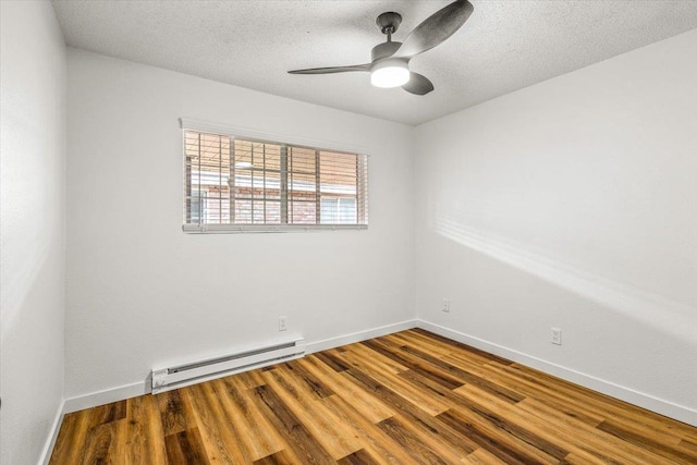 917 E Indiana Ave, Spokane, WA 99207 - spare room featuring a baseboard radiator, wood finished floors, baseboards, a ceiling fan, and a textured ceiling