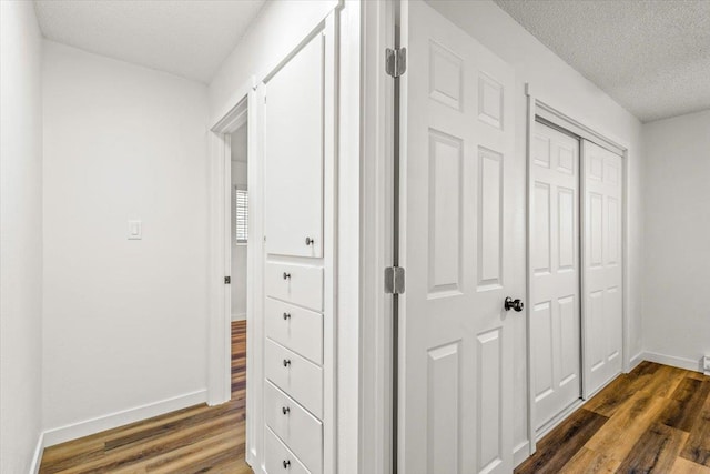 917 E Indiana Ave, Spokane, WA 99207 - hallway featuring dark wood-style floors, baseboards, and a textured ceiling