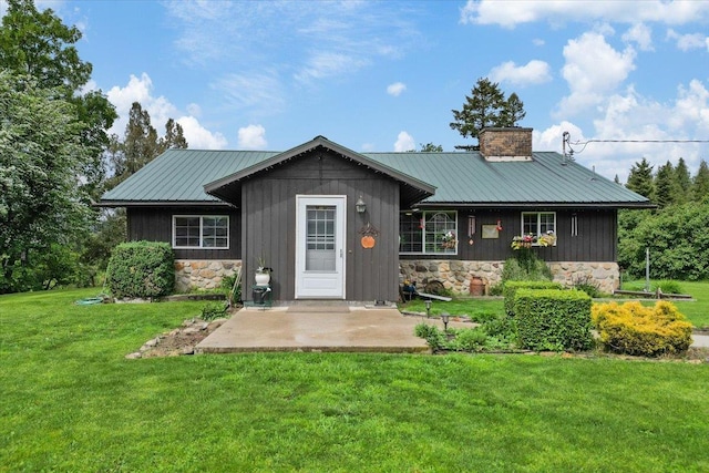 3720 E Bridges Rd, Elk, WA 99009 - ranch-style house with stone siding, a front lawn, a chimney, and metal roof
