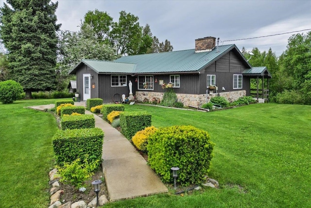 3720 E Bridges Rd, Elk, WA 99009 - view of front of property featuring a chimney, a front lawn, metal roof, and stone siding
