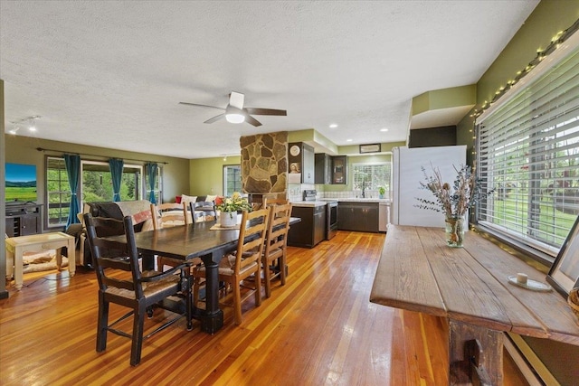 3720 E Bridges Rd, Elk, WA 99009 - dining room featuring light wood finished floors, a ceiling fan, plenty of natural light, and a textured ceiling