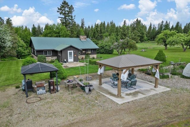 3720 E Bridges Rd, Elk, WA 99009 - rear view of house with a gazebo, metal roof, a yard, and a chimney