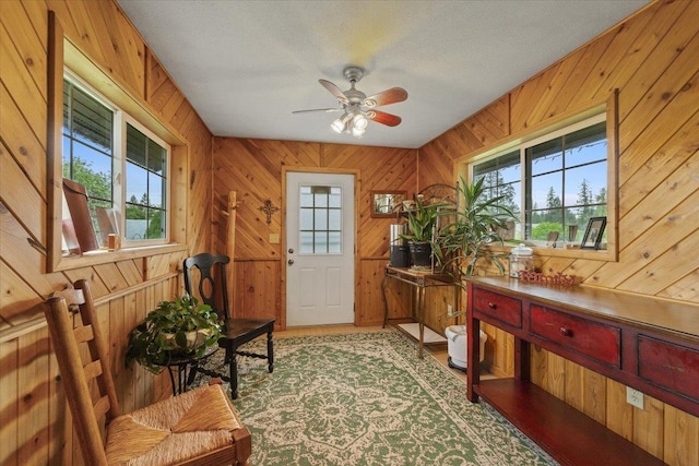 3720 E Bridges Rd, Elk, WA 99009 - doorway to outside featuring wooden walls, ceiling fan, and light wood-style flooring