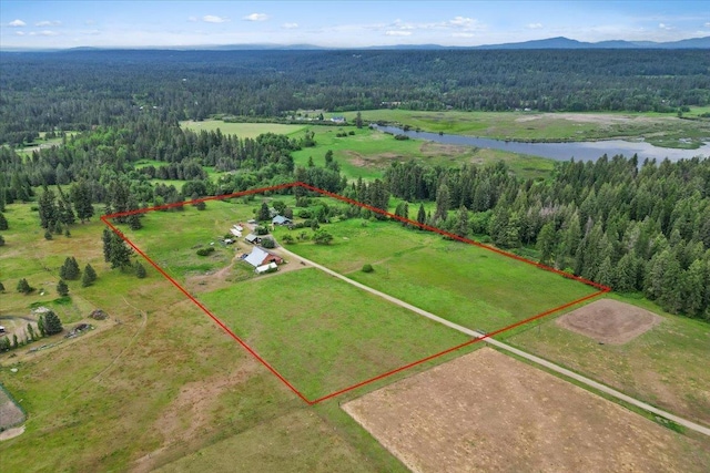3720 E Bridges Rd, Elk, WA 99009 - aerial overview of property's location with a heavily wooded area, a water and mountain view, and property parcel outlined