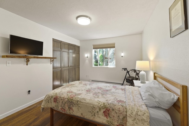 112 E Weile Ave Unit # 1, Spokane, WA 99208 - bedroom with wood finished floors, a baseboard radiator, baseboards, and a closet