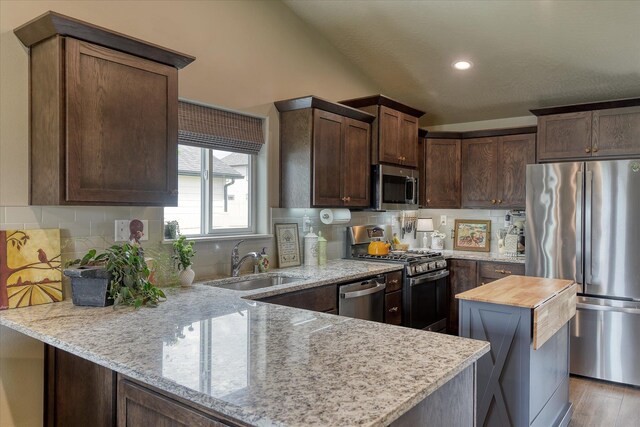 8202 W Quaking Rd, Spokane, WA 99224 - kitchen with stainless steel appliances, a sink, light stone countertops, backsplash, and recessed lighting