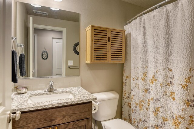 8202 W Quaking Rd, Spokane, WA 99224 - full bathroom with vanity, toilet, tasteful backsplash, and a shower with curtain