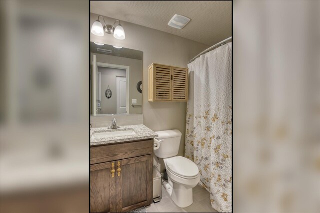 8202 W Quaking Rd, Spokane, WA 99224 - full bathroom featuring vanity, toilet, and tile patterned floors