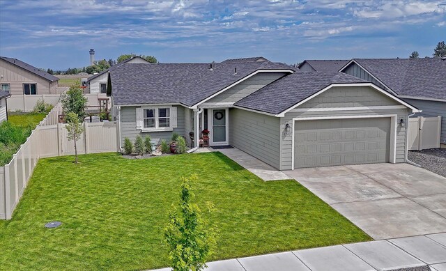 8202 W Quaking Rd, Spokane, WA 99224 - view of front of home featuring an attached garage, a shingled roof, and driveway