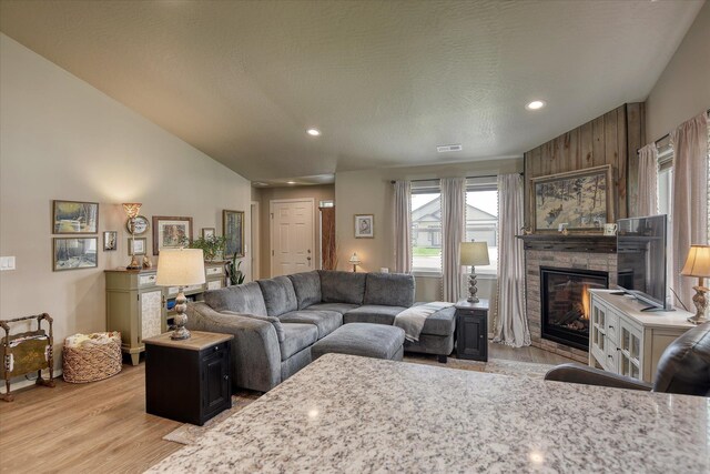 8202 W Quaking Rd, Spokane, WA 99224 - living room with a large fireplace, light wood-style flooring, recessed lighting, and lofted ceiling