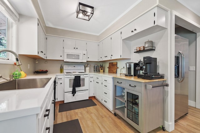 1919 E 59th Ave, Spokane, WA 99223 - kitchen with white appliances, a sink, light wood finished floors, light countertops, and backsplash