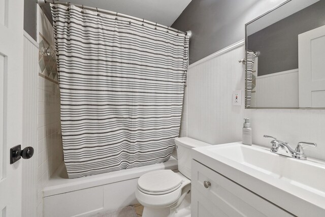 1919 E 59th Ave, Spokane, WA 99223 - bathroom with vanity, shower / bathtub combination with curtain, toilet, and a wainscoted wall