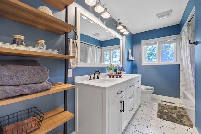 1919 E 59th Ave, Spokane, WA 99223 - bathroom featuring vanity, toilet, baseboards, and shower / bath combination with curtain