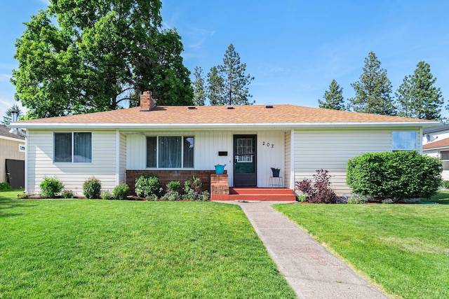 202 W Columbia Ave, Spokane, WA 99205 - ranch-style home featuring a front yard, a chimney, and brick siding