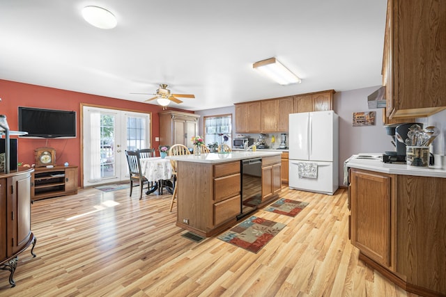 202 W Columbia Ave, Spokane, WA 99205 - kitchen with freestanding refrigerator, black dishwasher, light wood-style flooring, and light countertops