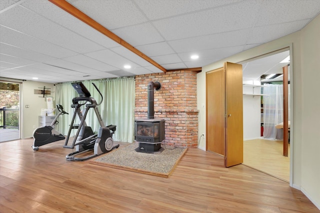 13625 S Sherman Rd, Spokane, WA 99224 - workout area featuring a wood stove, wood finished floors, and a drop ceiling
