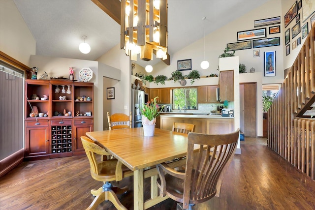 13625 S Sherman Rd, Spokane, WA 99224 - dining area with high vaulted ceiling, dark wood-style floors, and stairway