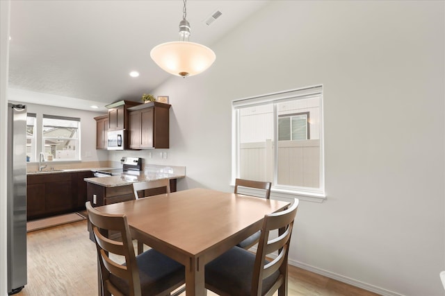 8620 W 8th Ave, Spokane, WA 99224 - dining room featuring light wood finished floors, high vaulted ceiling, and recessed lighting