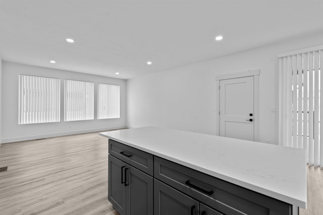 3617 E 1st Ave, Spokane, WA 99202 - kitchen featuring light wood finished floors, recessed lighting, open floor plan, a kitchen island, and gray cabinetry