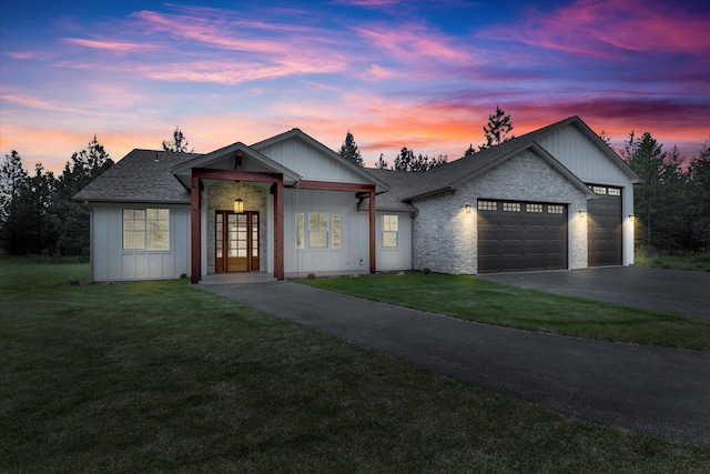 1399 W Findley Ln, Deer Park, WA 99006 - view of front facade featuring driveway, a garage, a lawn, a shingled roof, and board and batten siding