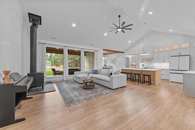 1399 W Findley Ln, Deer Park, WA 99006 - living room with a wood stove, a ceiling fan, high vaulted ceiling, light wood-style floors, and recessed lighting