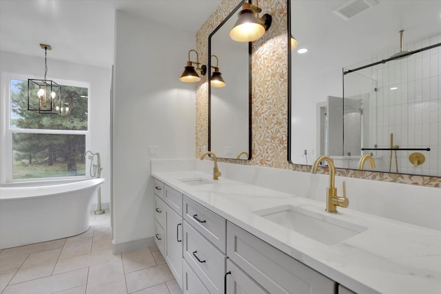 1399 W Findley Ln, Deer Park, WA 99006 - bathroom with a stall shower, double vanity, a freestanding tub, tile patterned floors, and a chandelier