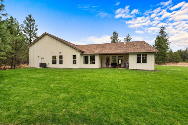 1399 W Findley Ln, Deer Park, WA 99006 - rear view of house featuring central air condition unit, a lawn, board and batten siding, and roof with shingles