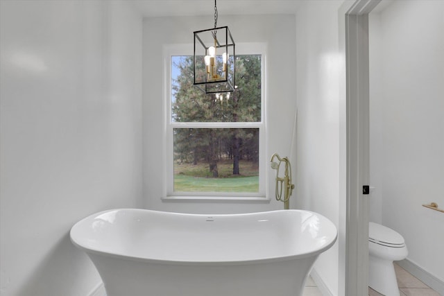 1399 W Findley Ln, Deer Park, WA 99006 - bathroom with a freestanding bath, baseboards, toilet, and tile patterned flooring