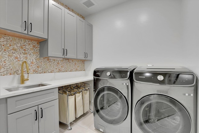 1399 W Findley Ln, Deer Park, WA 99006 - washroom featuring washer and clothes dryer, cabinet space, and light tile patterned floors