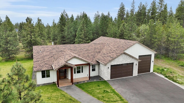 1399 W Findley Ln, Deer Park, WA 99006 - modern farmhouse with board and batten siding, a garage, a front yard, covered porch, and asphalt driveway