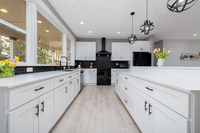 5125 N Ellie Ln, Spokane, WA 99217 - kitchen with black appliances, wall chimney exhaust hood, a sink, decorative backsplash, and recessed lighting